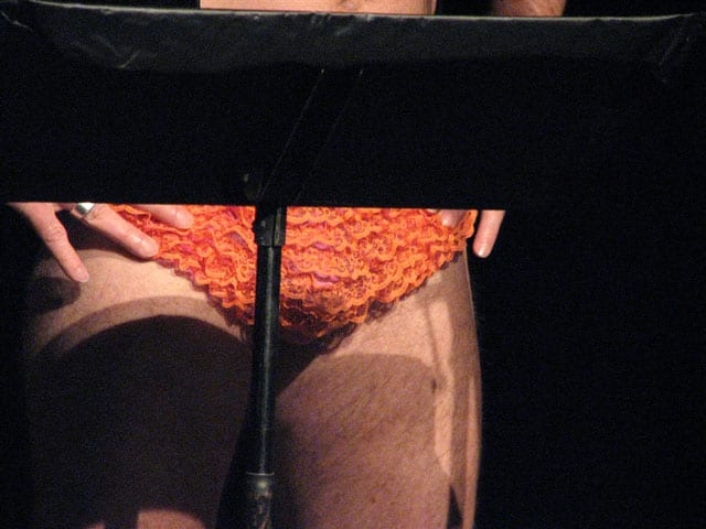 Close up shot of a crotch with orange ruffled panties