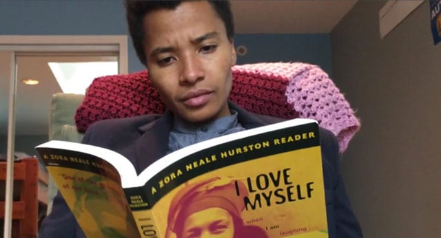 african american woman reading I love myself book